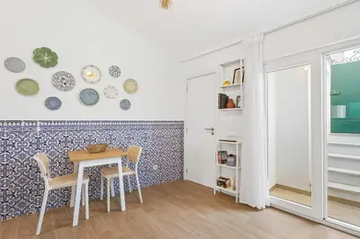 a dining room with a table and chairs at Pátio da Luz 1Bdr House by LovelyStay in Luz