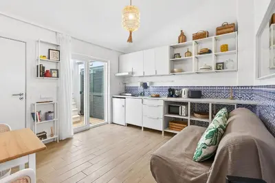 a living room with a couch and a kitchen at Pátio da Luz 1Bdr House by LovelyStay in Luz