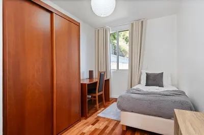 a bedroom with a white bed with orange pillows at Johns Villa by Homie in Canhas