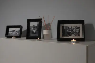 a shelf with three pictures and candles on it at Apartamentos Baptista by AnaLodges in Funchal