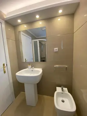 a bathroom with a sink and a toilet and a mirror at Apartamentos Baptista by AnaLodges in Funchal