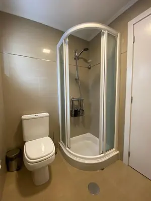 a bathroom with a toilet and a shower at Apartamentos Baptista by AnaLodges in Funchal
