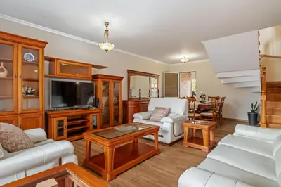 a living room filled with furniture and a flat screen tv at Casa Helena in Calheta