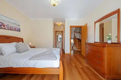 a bedroom with a bed and a dresser and a mirror at Casa Helena in Calheta