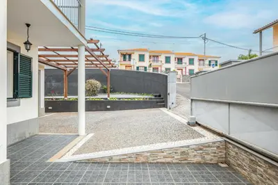 an empty courtyard of a house with a fence at Casa Helena in Calheta