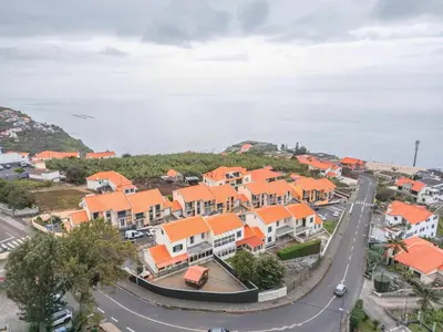 an aerial view of a town with orange roofs at Casa Helena in Calheta