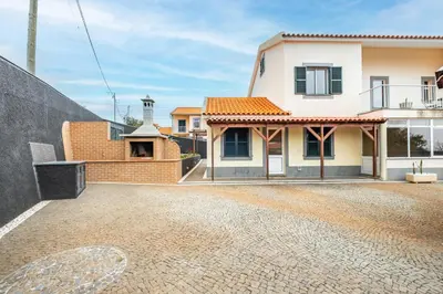 a house with a brick driveway in front of it at Casa Helena in Calheta
