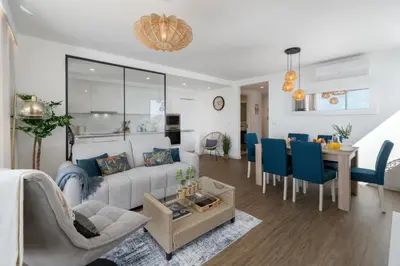 a living room with a couch and a dining room at Premium apartment panoramic seaview AtlanticFrame in Câmara de Lobos