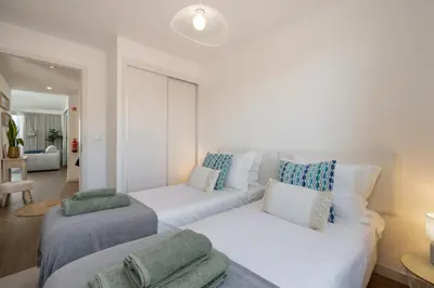 a living room with two beds and a couch at Premium apartment panoramic seaview AtlanticFrame in Câmara de Lobos
