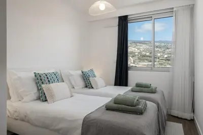 a living room with a couch and a large window at Premium apartment panoramic seaview AtlanticFrame in Câmara de Lobos