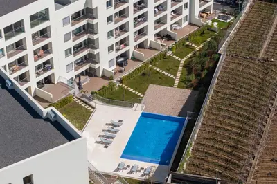 an overhead view of a building with a swimming pool at Premium apartment panoramic seaview AtlanticFrame in Câmara de Lobos