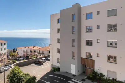 an apartment building with a view of the ocean at Premium apartment panoramic seaview AtlanticFrame in Câmara de Lobos