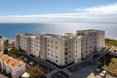 an overhead view of a building with the ocean in the background at Premium apartment panoramic seaview AtlanticFrame in Câmara de Lobos