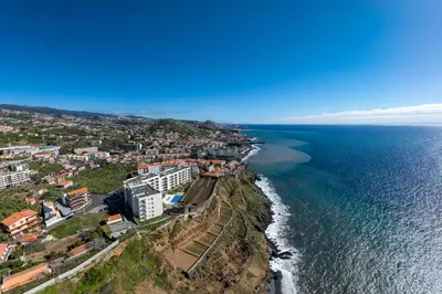 an aerial view of a city and the ocean at Premium apartment panoramic seaview AtlanticFrame in Câmara de Lobos