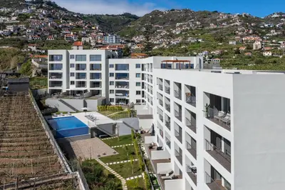an aerial view of a white apartment building at Premium apartment panoramic seaview AtlanticFrame in Câmara de Lobos