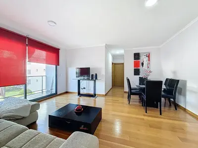 a living room with a couch and a table at Sea Garden in Caniço
