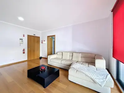 a living room with a couch and a coffee table at Sea Garden in Caniço