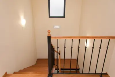 a staircase in a house with a picture on the wall at Vivenda Fortim in Faial