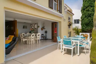 a kitchen and dining room with a table and chairs at Villa Beach Club in Santa Cruz