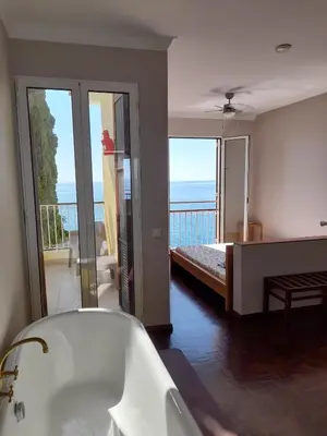 a bathroom with a yellow tub and a sink at Villa Beach Club in Santa Cruz