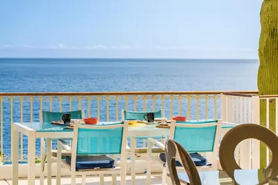 a living room with a view of the ocean at Villa Beach Club in Santa Cruz