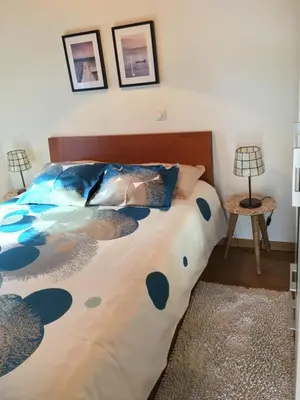 a bedroom with a large bed with a large comforter at BHF Residences Bordadeira in Arco da Calheta