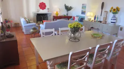 a living room with a table with a vase of flowers on it at Salt Water Villa in Santa Cruz