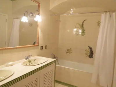 a bathroom with two sinks and a shower and a tub at Salt Water Villa in Santa Cruz