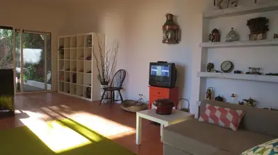 a living room with a couch and a tv at Salt Water Villa in Santa Cruz