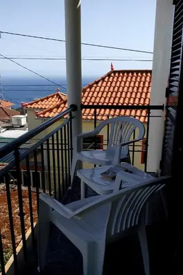 two white chairs sitting on a balcony with a view at Casa do Moinho in Santa Cruz