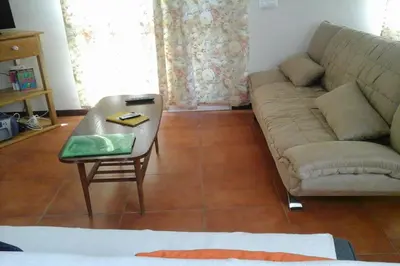 a living room with a couch and a table at Casa do Moinho in Santa Cruz
