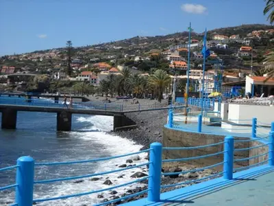 a bridge over a beach next to a river at Casa do Moinho in Santa Cruz