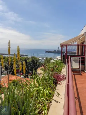 a balcony of a house with a view of the ocean at Arriaga Marina Club Apartament in Funchal
