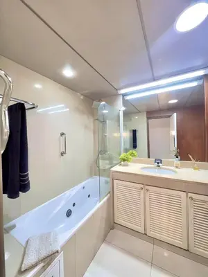 a bathroom with a tub and a sink and a shower at Arriaga Marina Club Apartament in Funchal