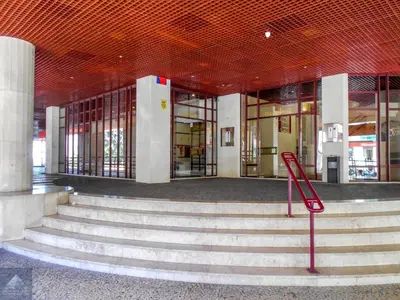 a building with stairs and a sign in front of it at Arriaga Marina Club Apartament in Funchal