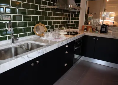 a kitchen with a sink and a counter with glasses on it at Apartment Serrão in Funchal