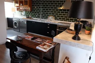 a kitchen with a table with a lamp on it at Apartment Serrão in Funchal