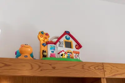 a toy house sitting on top of a wooden shelf at Apt. Downtown 2 in Funchal