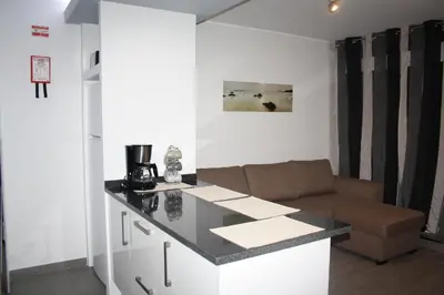 a kitchen with a counter and a couch in a room at Ventur Flat in Caniço