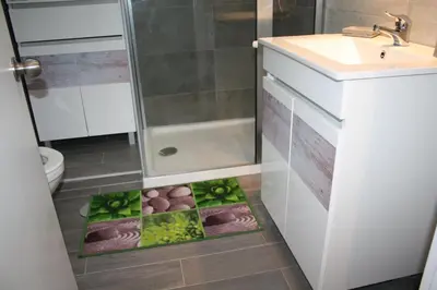 a bathroom with a plate of food on the floor at Ventur Flat in Caniço