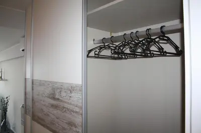 a bunch of metal hangers in a room at Ventur Flat in Caniço