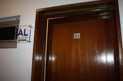 a wooden door with the number on it at Ventur Flat in Caniço