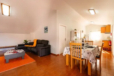 a living room with a table and a couch at Apartamento Celia in Arco da Calheta