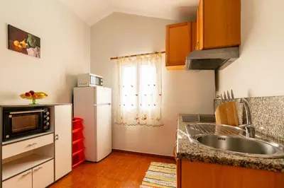 a small kitchen with a sink and a refrigerator at Apartamento Celia in Arco da Calheta
