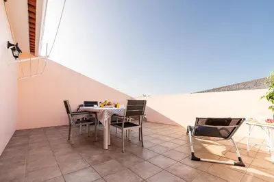 a dining room with a table and chairs at Apartamento Celia in Arco da Calheta