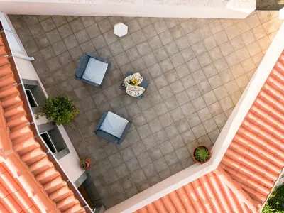 an overhead view of a patio with chairs and tables at Apartamento Celia in Arco da Calheta