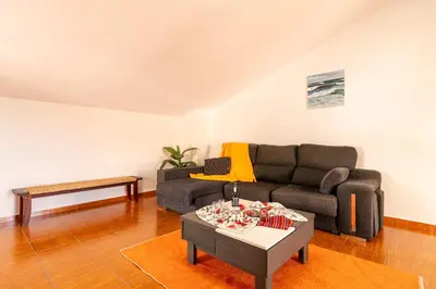 a living room with a couch and a coffee table at Apartamento Celia in Arco da Calheta