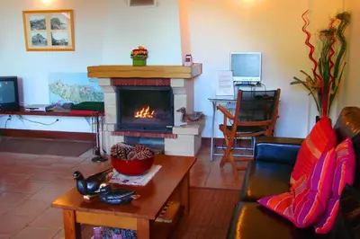 a living room with a fireplace and a couch at Villa Ricardo in Porto da Cruz