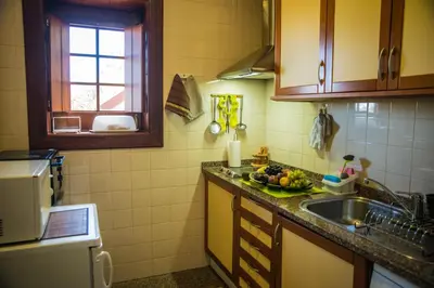 a kitchen with a sink and a plate of fruit on the counter at Villa Ricardo in Porto da Cruz