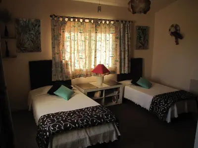 a bedroom with two beds and a window at Highview Villa in Lagos
